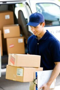 delivery man brings boxes to house