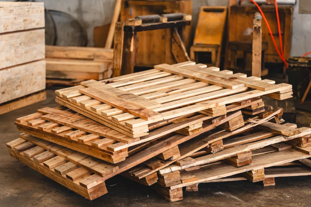 Wooden pallets toppled over in a warehouse.